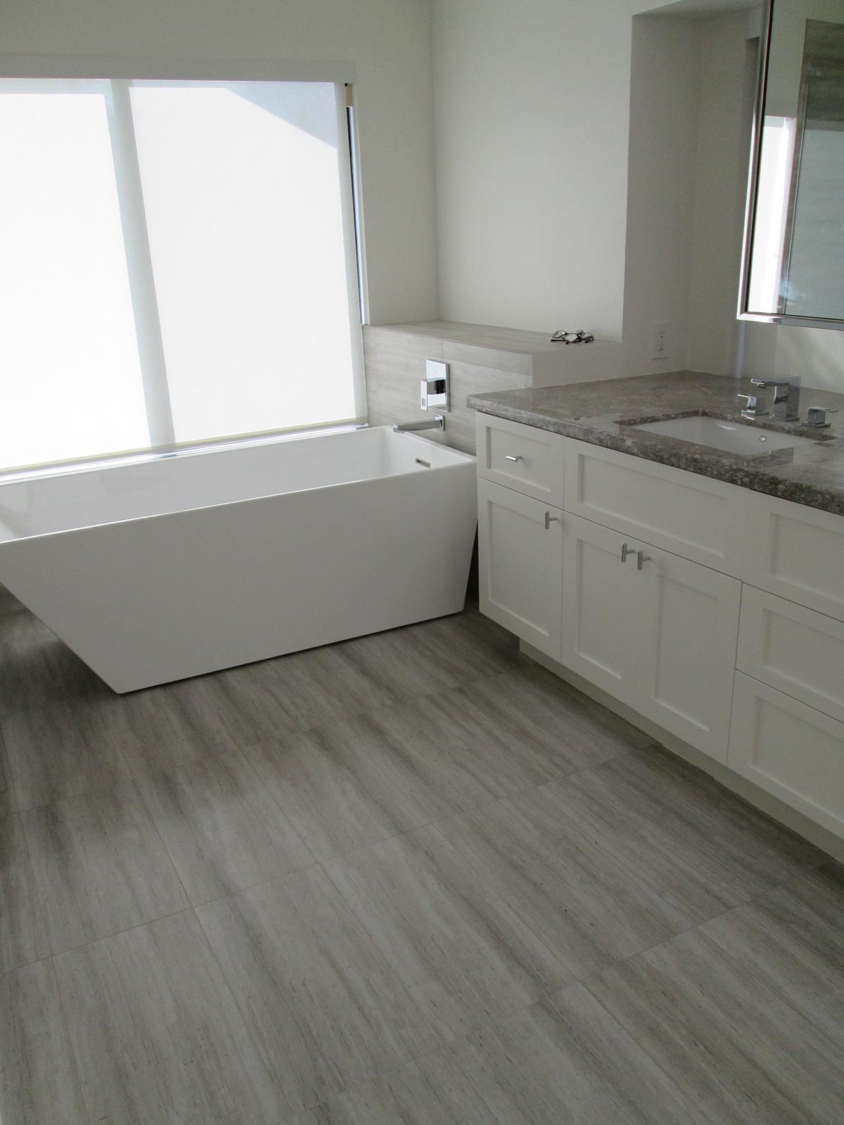 Modern bathroom remodel with soaking tub and vanity